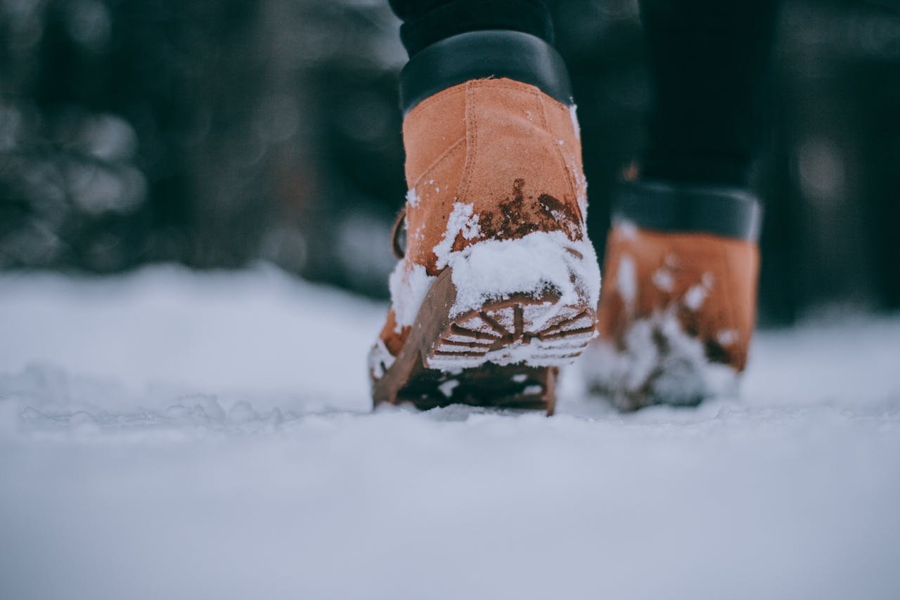 digital Close-up of person wearing boots walking in snow, capturing the essence of winter outdoors.