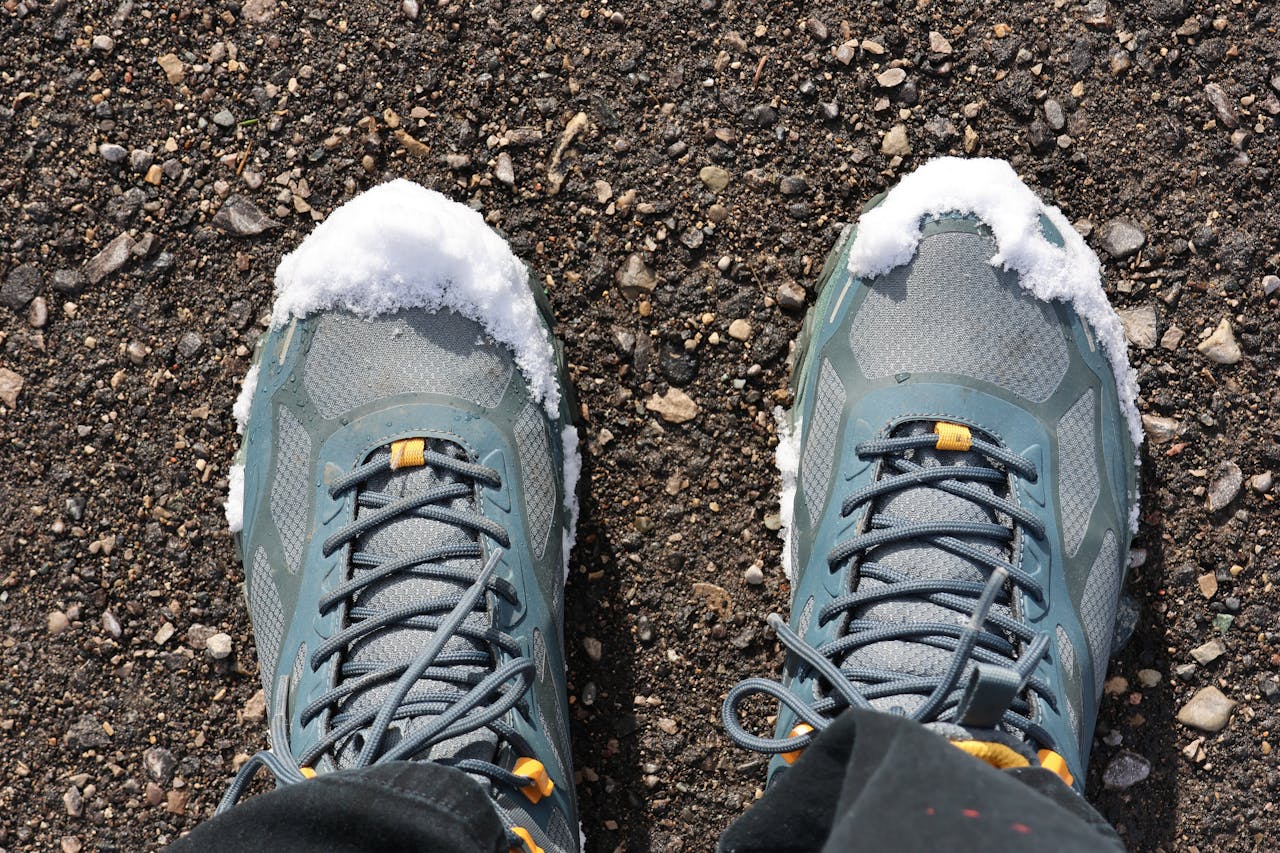 creative Close-up of hiking boots on a snowy trail, perfect for winter adventure themes.